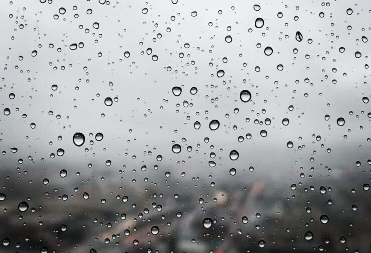 Raindrops on windowpane overlooking city; cover image for blog on succession planning for local government.